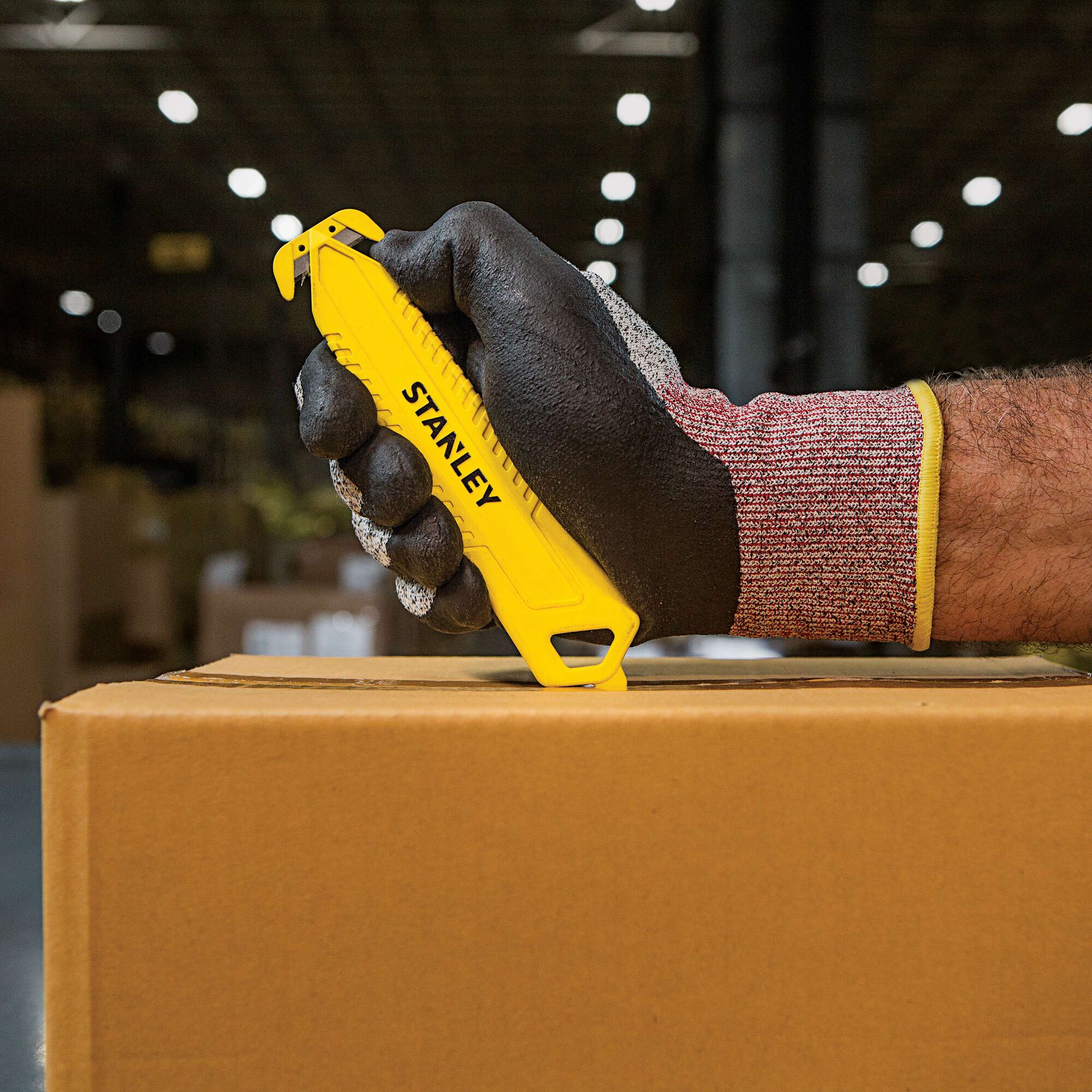Double Sided Pull Cutter being used for opening box.