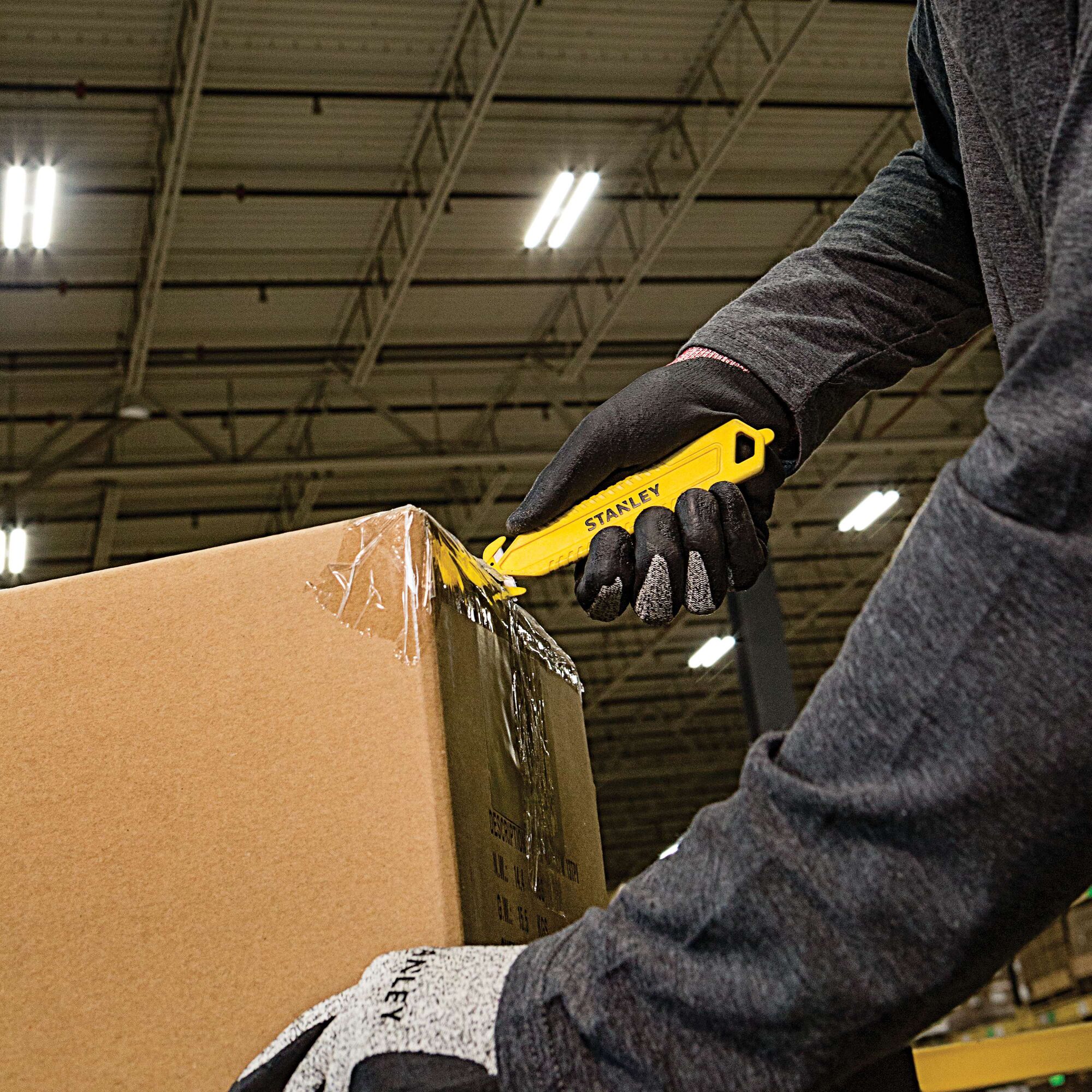 Double Sided Pull Cutter being used for opening package.
