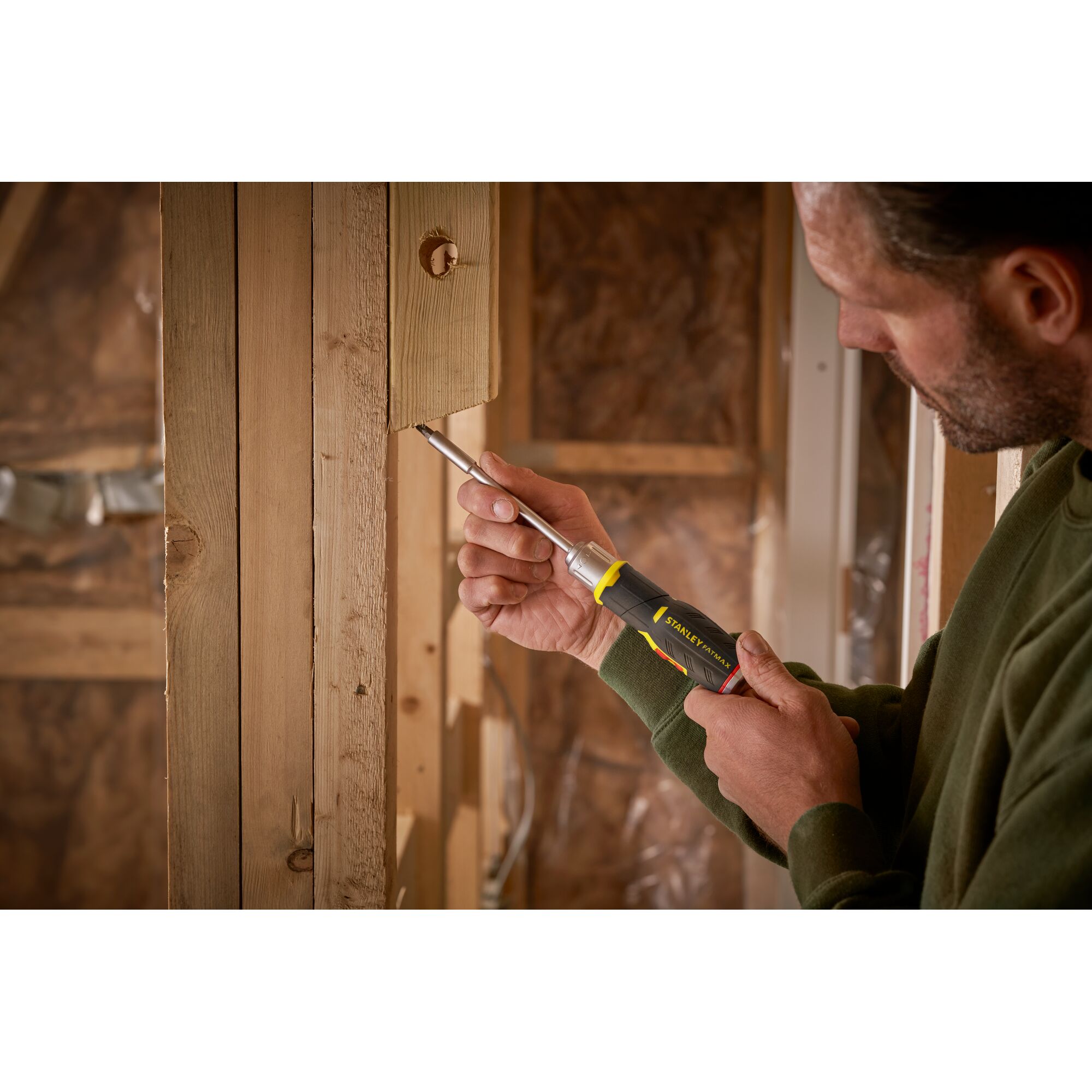Photo of STANLEY FMHT0-62691 screwdriver used on wooden frame in construction setting.